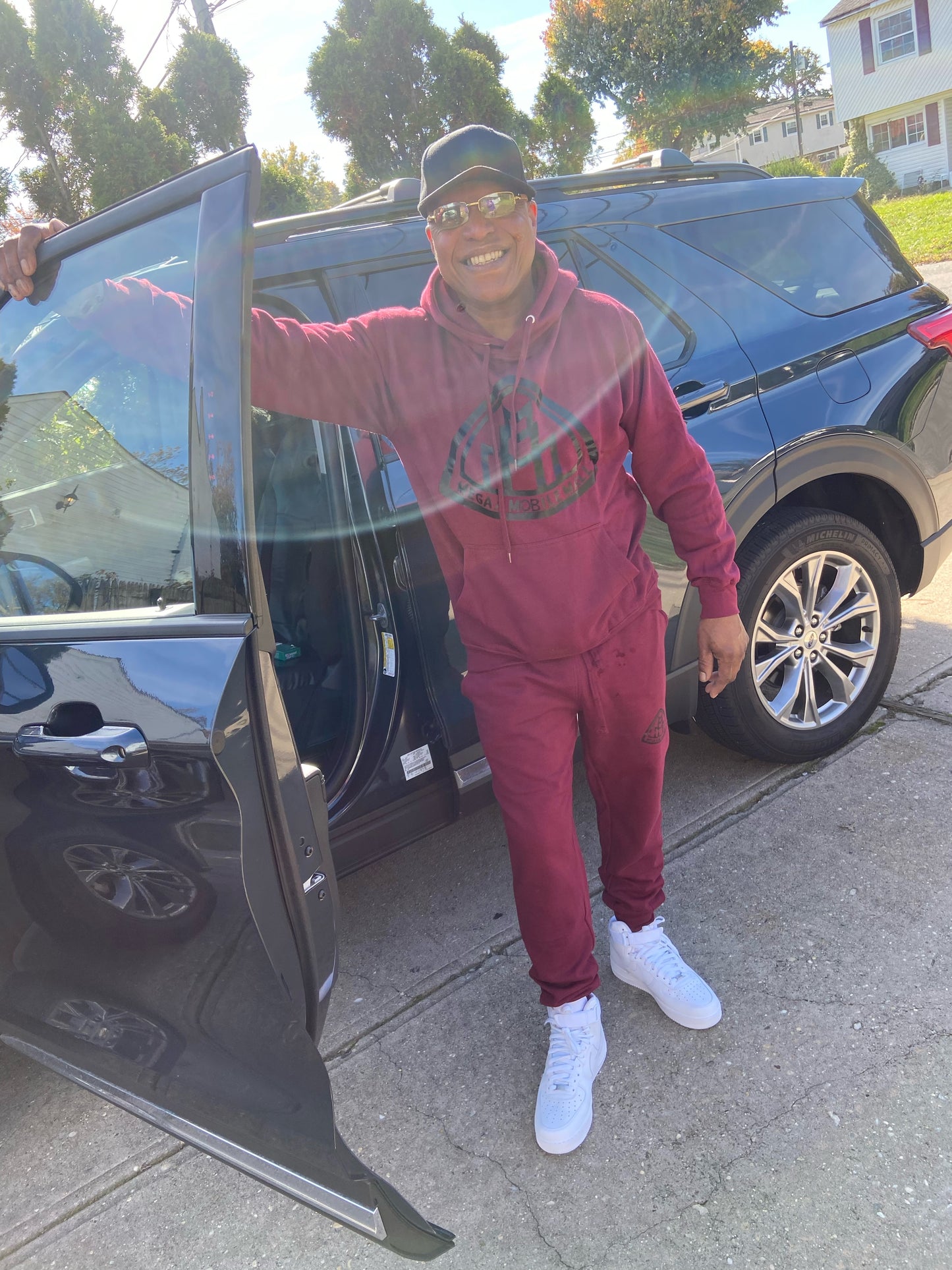 customer modeling our MEGAAMOBILEMALL LOGO Heavy Blend Fleece Hooded SweatSuits black logo